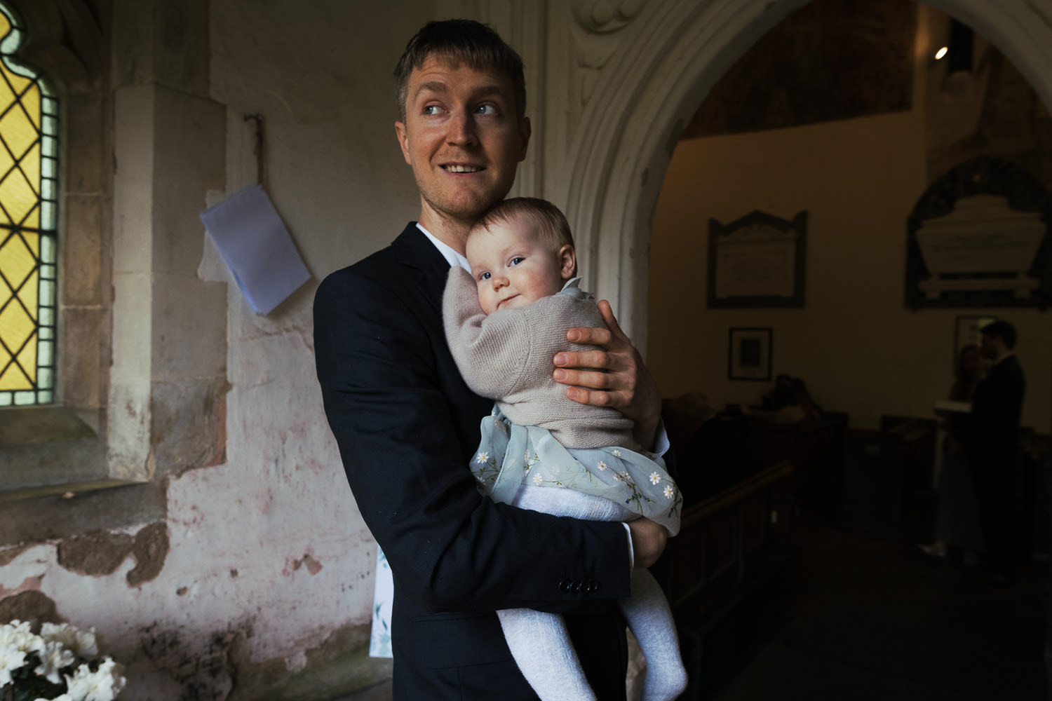 Man holding his baby in the Bartlow church doorway.