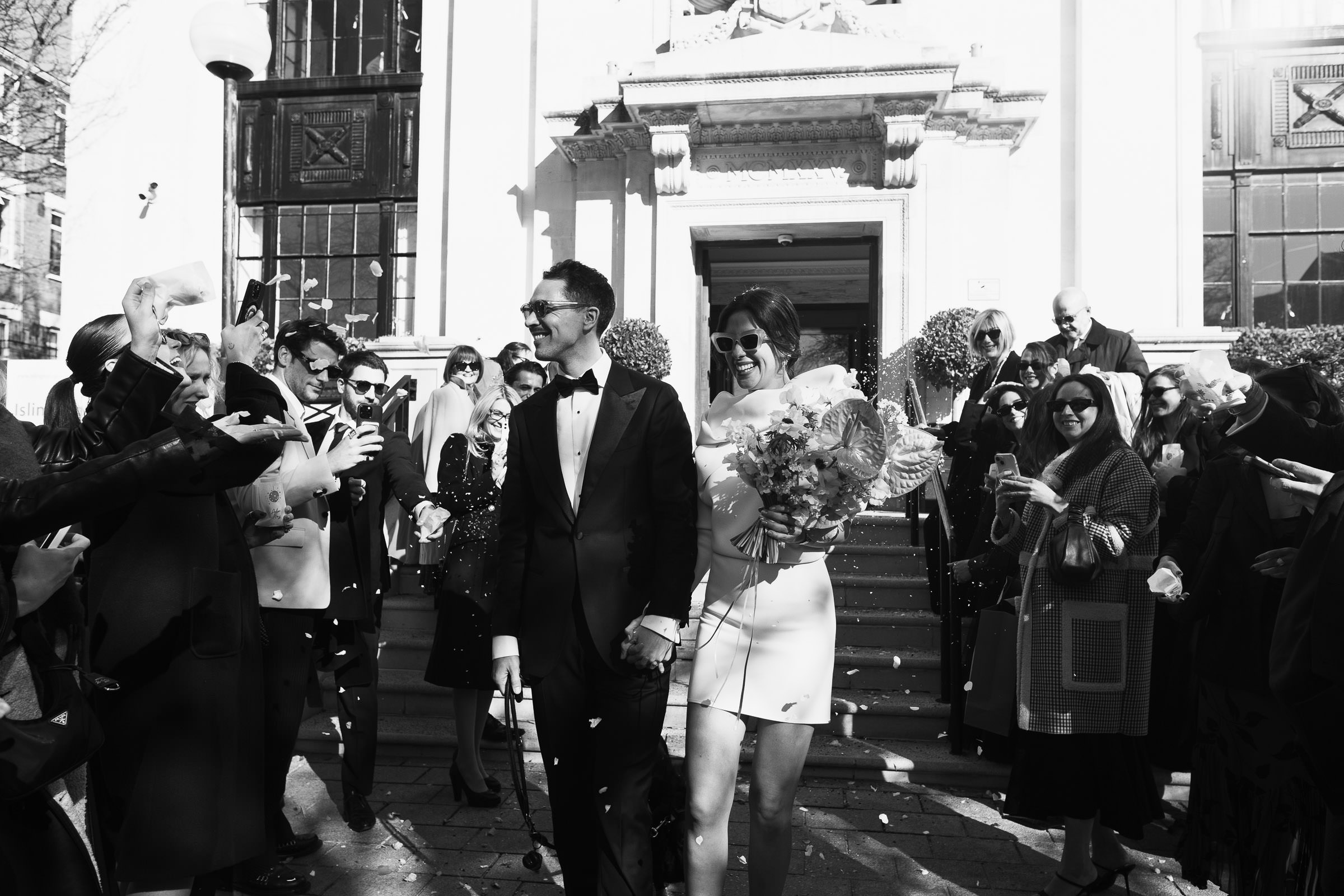 Registry office weddings London – confetti thrown at bride and groom outside Islington Town Hall.